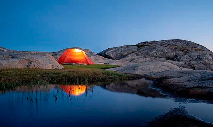 Camping gear tent near a lake 
