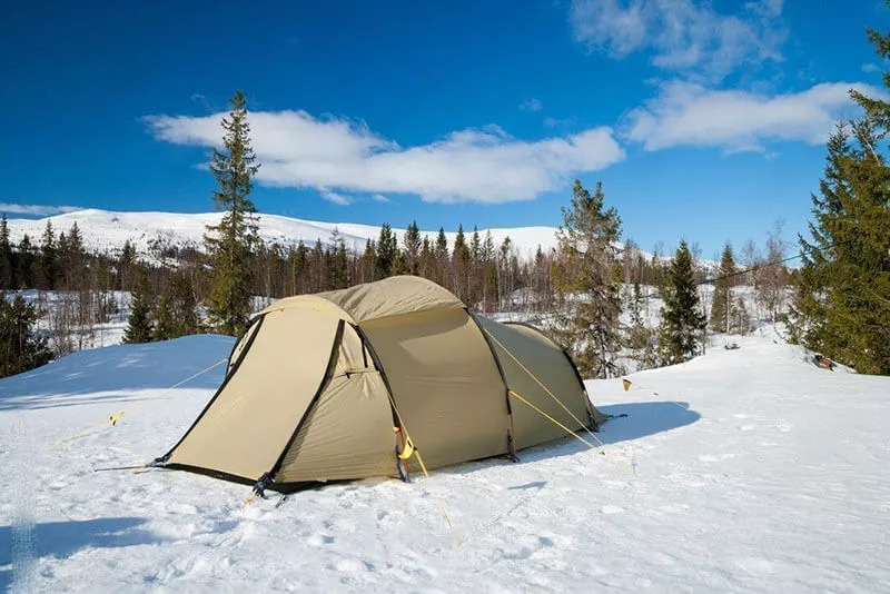 Making camp in the snow: Start by finding a suitable location. Make sure that the area is free of any large trees or branches that could fall and injure you. Choose an area that is flat so you don’t have to worry about your tent rolling down a hill in the middle of the night.